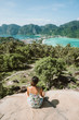 © Simon Dannhauer - Koh Phi Phi Don, Viewpoint - Girl enjoying beautiful view of paradise bay from the top of the tropical island. View from the back. Thailand.