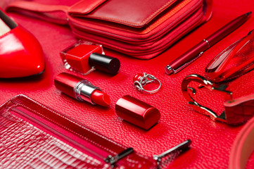 Woman red accessories, jewelry, cosmetic, shoes and other luxury objects on leather background, fashion industry, modern female concept, selective focus