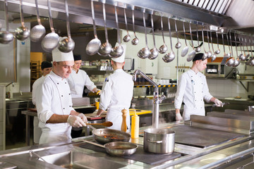 Wall Mural - the work of the cook in the kitchen of the restaurant.