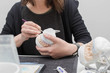 Dental technician working on plaster stone model with zirconium bridge and applying of ceramic