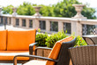 © Kristina Blokhin - Patio orange colorful lounge chairs in outdoor summer green garden in backyard porch of home plants furniture nobody in tropical