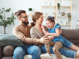 Wall Mural - happy family mother father and child daughter laughing   at home  .