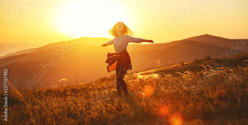 Fotomural Happy woman jumping and enjoying life at sunset in mountains.