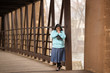 © cmlndm - Hispanic Woman Praying And Holding Bible On A Bridge