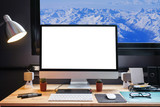 Fototapeta  - Graphic designer's workspace with a pen tablet, a computer and white backgroud for text with beautiful view of Snow moutain,France from Window
