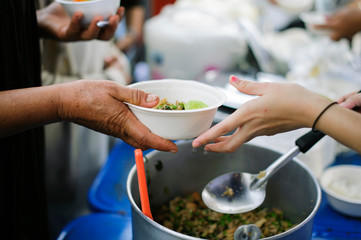 The hand holding food is a hope for the poor to get the opportunity to eat.