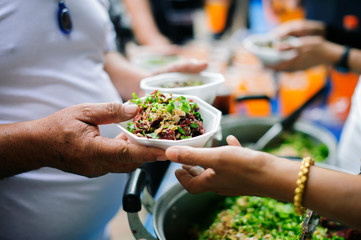 Volunteers collaborated to provide food to beggars with compassion.