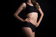 © Johnstocker - Beautiful woman with healthy body on black background