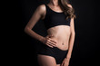 © Johnstocker - Beautiful woman with healthy body on black background