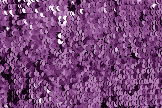 Glittering sequin texture in purple tone.
