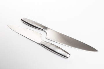 Set of steel kitchen knives on white background