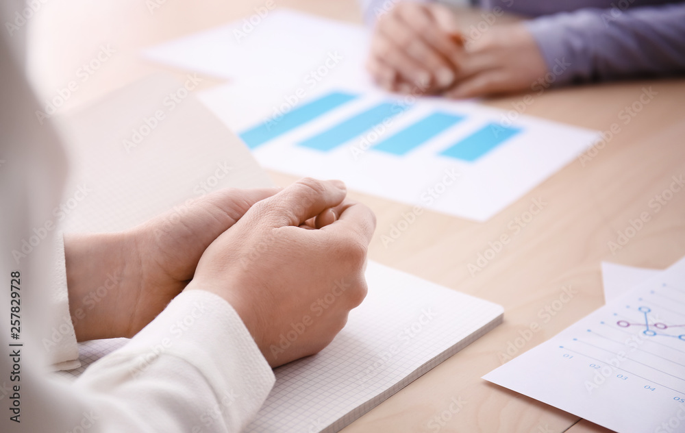 Woman sitting at table during business meeting