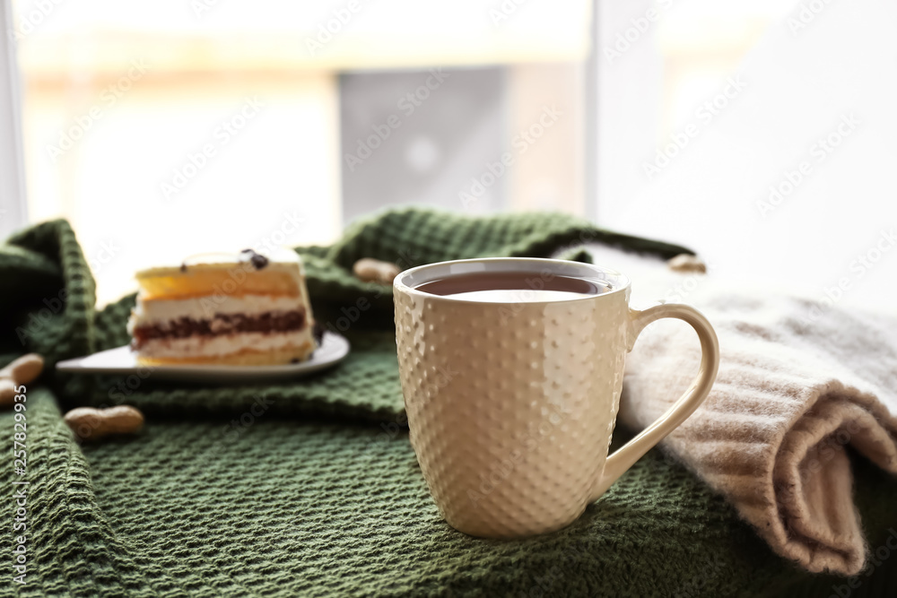 Cup of hot tea on plaid