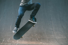 Skateboarder In Action. Extreme Sports Lifestyle. Hipster Performing Ollie Trick. Cropped Shot. Copy Space.