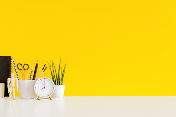 Wall Mural - Desk with stationery, succulent and yellow wall for copy space.