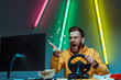 angry and good-looking man in glasses playing with steering wheel and throwing popcorn