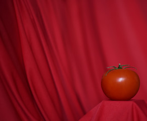 Poster - red tomato on red background