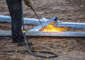 A worker cut steel beams using propane-oxygen torch..Oxy-fuel cutting.