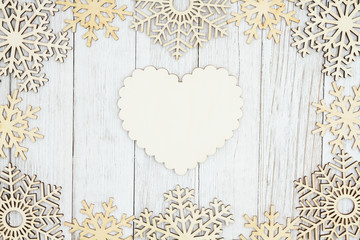 Wall Mural - Wood heart with wood snowflakes on weathered whitewash textured wood background