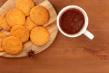 Fototapeta Kuchnia - A closeup of ginger cookies, shot from above with a cup of hot chocolate and an anise star on a dark rustic wooden background with copy space