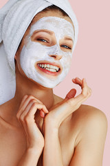 Wall Mural - beautiful young woman applying facial mask on her face. skin care and treatment, spa, natural beauty