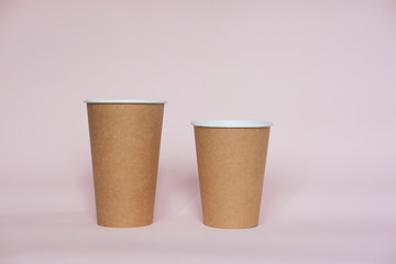 Wall Mural - Coffee cup on pink paper background. A couple of paper cups of coffee to take away.