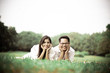 © ic36006 - Portrait of happy  young asian couple laying on grass In public park.