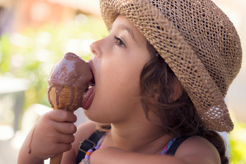 Girl licking an ice cream that melts in her hand