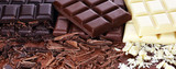 chocolate in diffrent color. milk, dark and white chocolate bars on table