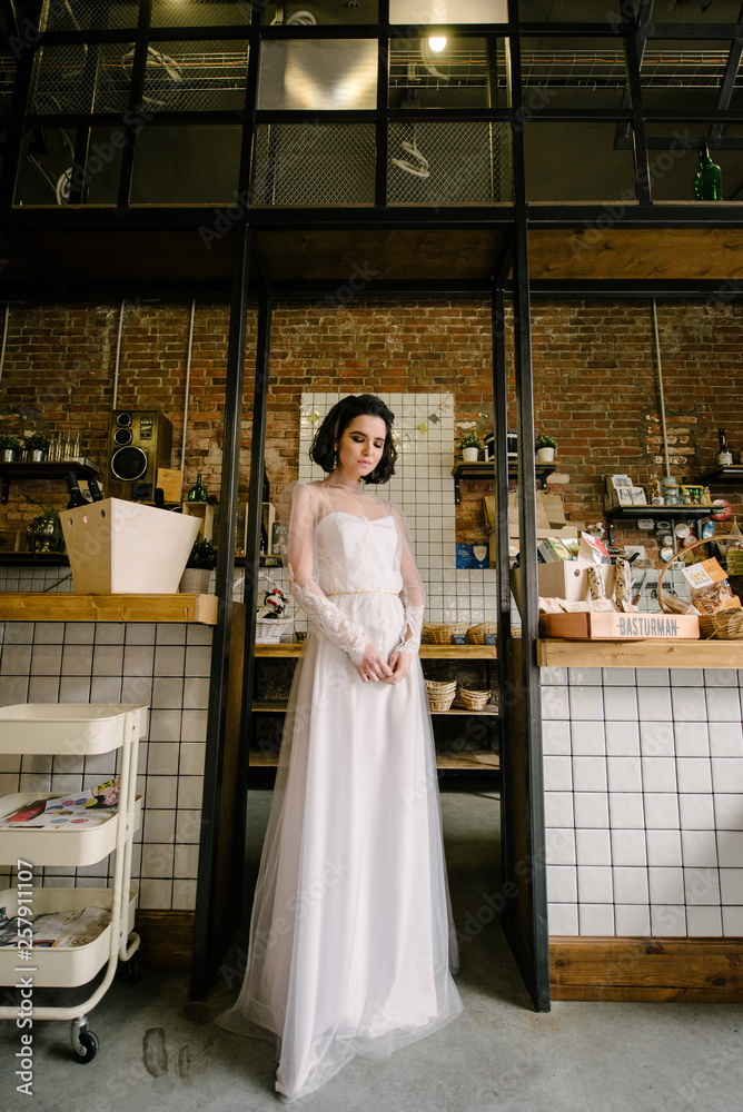 Model brunette in short hair posing in a white wedding dress. Advertising wedding dresses Stock Photo | Adobe Stock Model brunette in short hair posing in a white wedding dress. Advertising wedding dresses Stock Photo | Adobe Stock