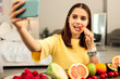 Woman making a selfie while eating healthy food