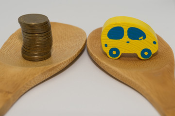 Toy car and stack of coins isolated on white background