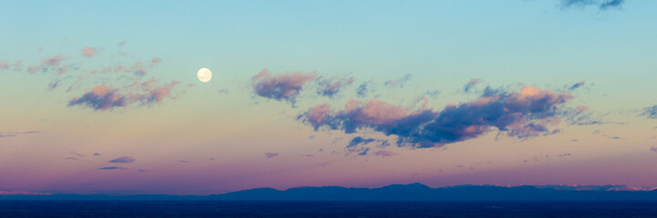 Wall Mural - Dawn sunrise pink clouds in sky with full moon background. Beautiful skies. Sunset inspiring view and scenery. Heavenly sky. Ethereal fantasy background.