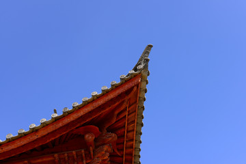 The corner of the ancient building against the blue sky