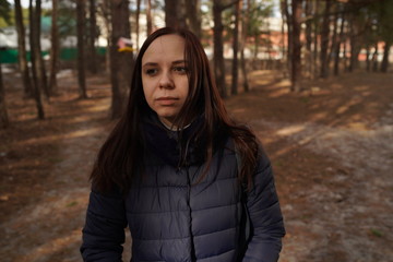 Girl walking in the woods. Traveler in nature.