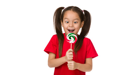 Wall Mural - Beautiful surprised little child girl with sweet candy lollipop isolated on white background