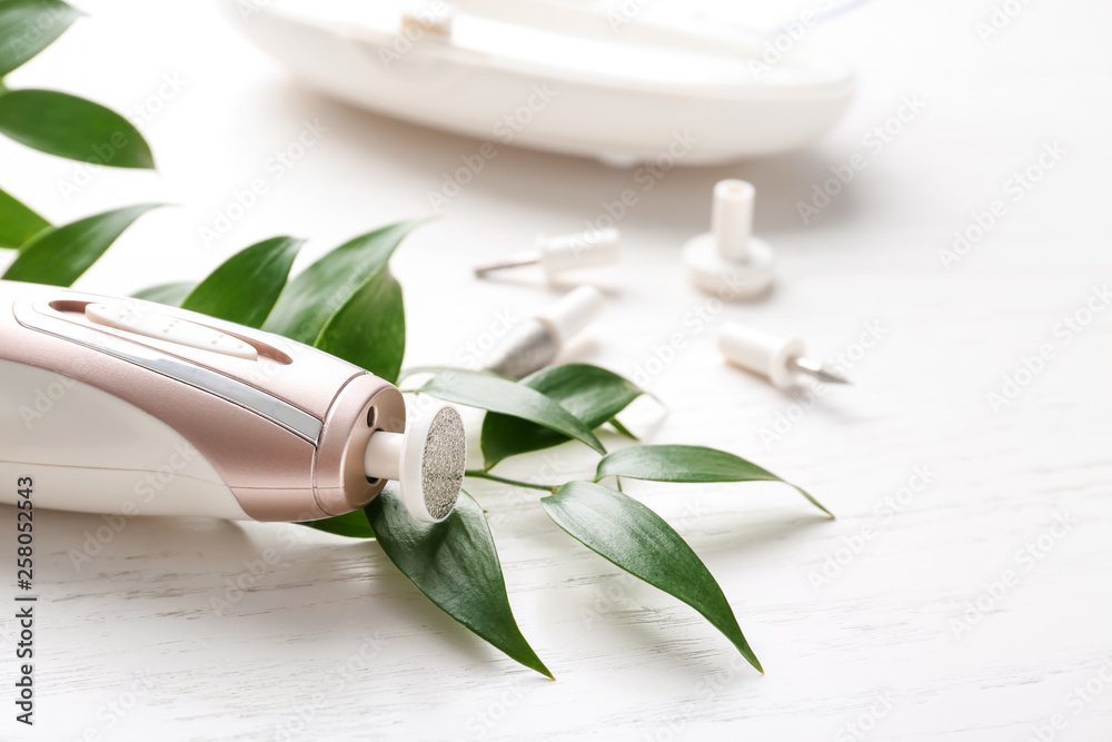 Pedicure milling cutter on white wooden background