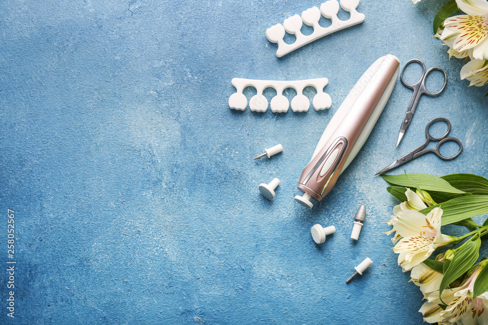 Tools for professional pedicure on color background