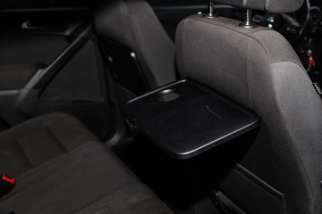 Wall Mural - Сlose-up of the car  black interior: rear seats and table with coasters.