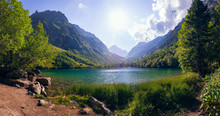 A Huge Panorama Of The High-mountainous Baduk Lake Among The High Caucasian Mountains And Beautiful Trees. Sunny Summer Day.