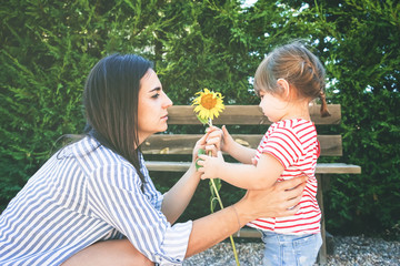 Wall Mural - Mom and daughter having fun together in a park