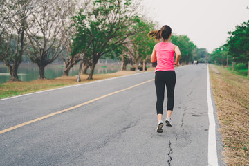 Healthy woman runner running exercise jogging on road, Woman fitness jog workout in the park during sunset