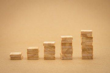 stack of wood businessmen standing Investment Analysis Or investment. The concept of being the number one business in the world stands at its peak.