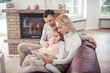 © Kristina89 - Emotional family portrait by burning fireplace in cozy home