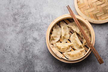 Wall Mural - Asian dumplings in bamboo steamer