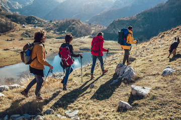 Poster - Group of hikers walking on a mountain at autumn day