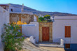 Greek architecture with traditional doors and decorative pavement in Lindos town, Rhodes island, Greece.