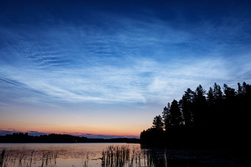 Wall Mural - night shining clouds over lake
