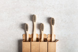 Fototapeta Sypialnia - A family set of four wooden bamboo toothbrushes