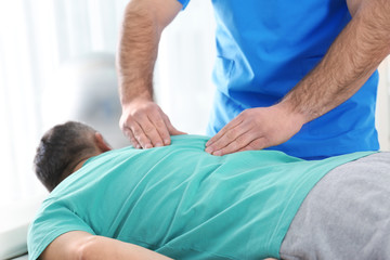 Canvas Print - Doctor working with patient in hospital, closeup. Rehabilitation massage